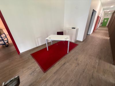 a room with a red carpet and a white table