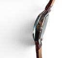 an image of a close up of a watch on a white surface