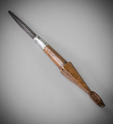 a close up of a knife with a wooden handle on a table