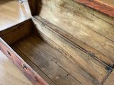 a wooden trunk sitting on the floor in a room