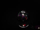 an image of a shiny glass ball in the dark