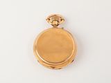 an antique gold pocket watch on a white surface