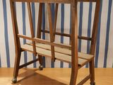 a wooden chair that is sitting on a wooden table