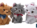 three stuffed animals sitting next to each other on a white background