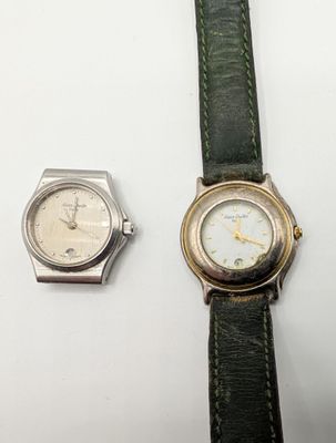 two watches sitting next to each other on a table
