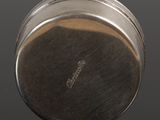 an image of a close up of a metal object on a black surface