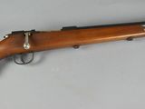 an old rifle with a wooden barrel and a metal handle