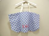 a blue and white checkered bag hanging on a hanger