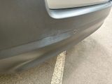 a close up of a car ' s bumper with a hole in it
