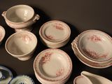 many plates and bowls that are sitting on a table
