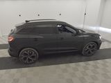 the black suv is parked in the garage of the building