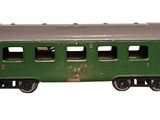 a green train car that is sitting on a white surface