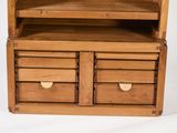 a wooden cabinet with two drawers and a door