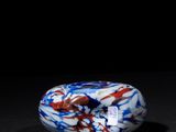 a close up of a marble on a black surface with a black background