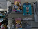 several stuffed animals are hanging on a wall in a store