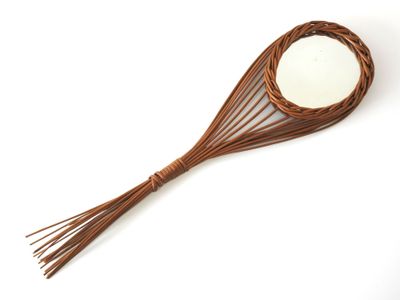a close up of a wooden spoon with a mirror on it