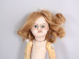 a doll that is sitting on a table with a banana in it