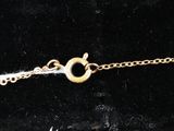a close up of a gold chain bracelet with a clasp