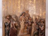 statue of a group of people standing in front of a building
