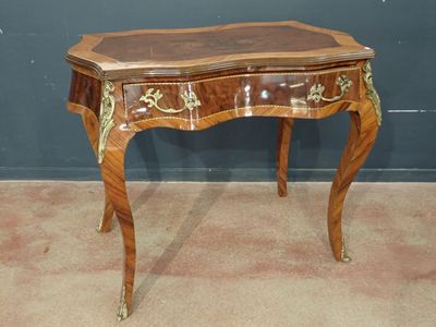 a small wooden table with a drawer on top of it