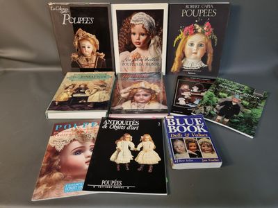 several books on a table with pictures of dolls on them