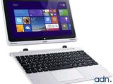 un ordinateur portable sur lequel sont posés un clavier et une souris