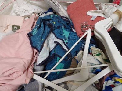 a pile of clothes and clothes in a suitcase