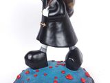 figurine of a man and woman kissing on top of a globe