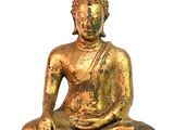 statue of a seated buddha on a white surface