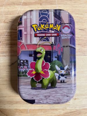 pokemon trading card game in a tin on a wooden table