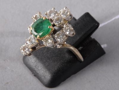 an image of a green and white diamond ring sitting on top of a black piece of wood