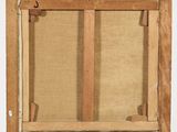 an old wooden easel with a painting hanging on it ' s side