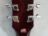 a close up of a guitar head with a flag on it