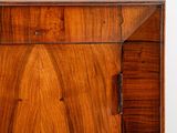 a close up of a wooden cabinet with a door