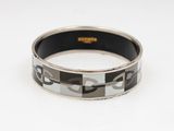 an image of a black and white bracelet on a white surface