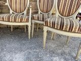 two chairs sitting next to each other on a gravel ground