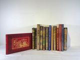 several books are lined up in a row on a white surface