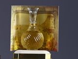 a bottle of perfume sitting on top of a box