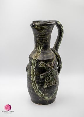un vase noir et vert orné d'un oiseau