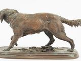 bronze statue of a dog on a wooden base on a white background
