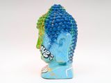 a statue of a buddha head made of blue and green beads