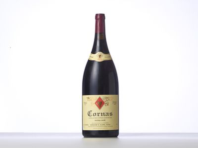 une bouteille de vin posée sur une table blanche