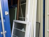 a blue shipping container that has a window and a window pane in it