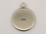 a silver pocket watch on a white surface