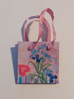 a small bag with a painting of flowers on it