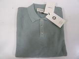 a close up of a polo shirt with a tag on it