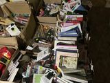 a pile of books sitting on the floor next to a pile of books