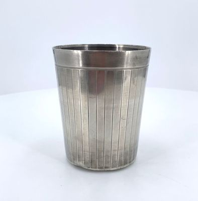 a metal cup that is sitting on a table
