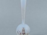 a white vase with a gold rim and a picture of a woman on it
