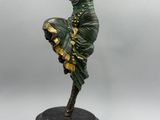 statue d'une femme en robe verte posée sur un socle noir